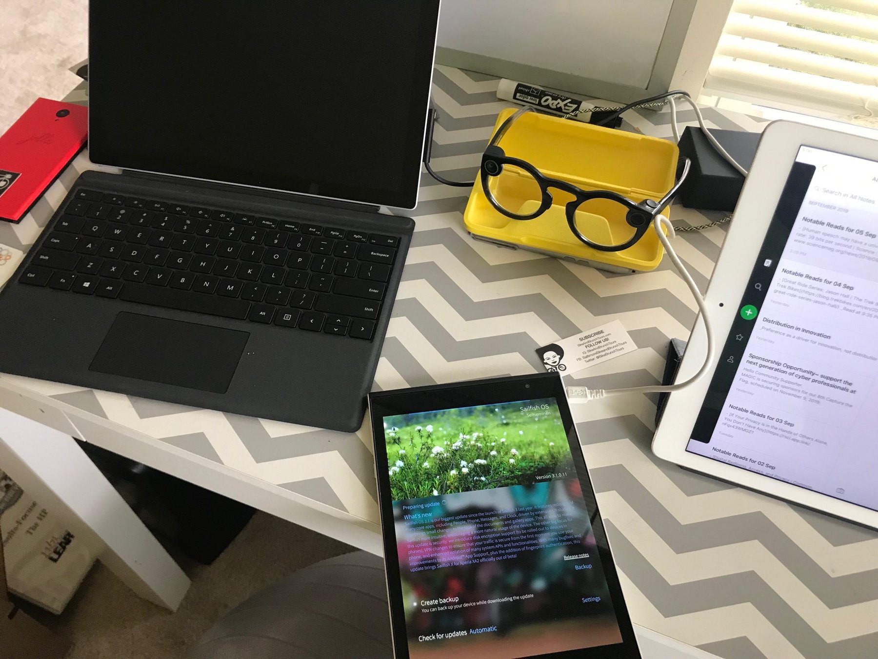 a few tablets, connected glasses, on a desk